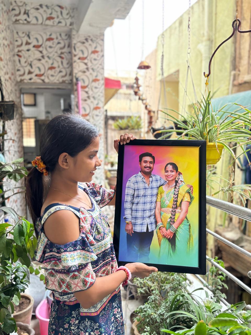 Woman holding framed couple photo, perfect personalized gift for Indian occasions and home decor