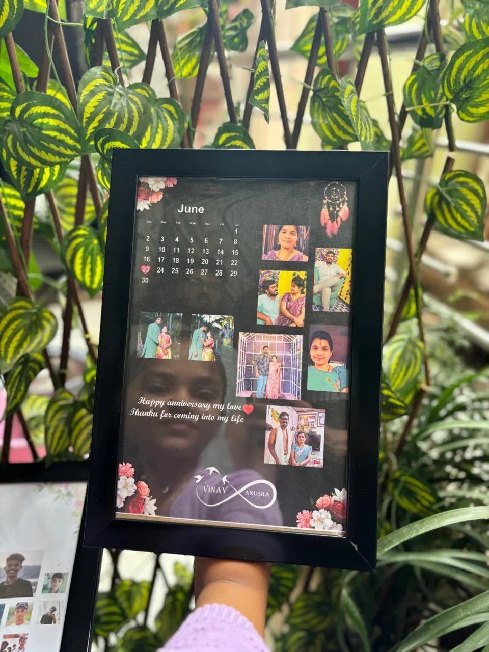 Personalized photo calendar with June dates, family pics, and anniversary message, framed in black with floral accents