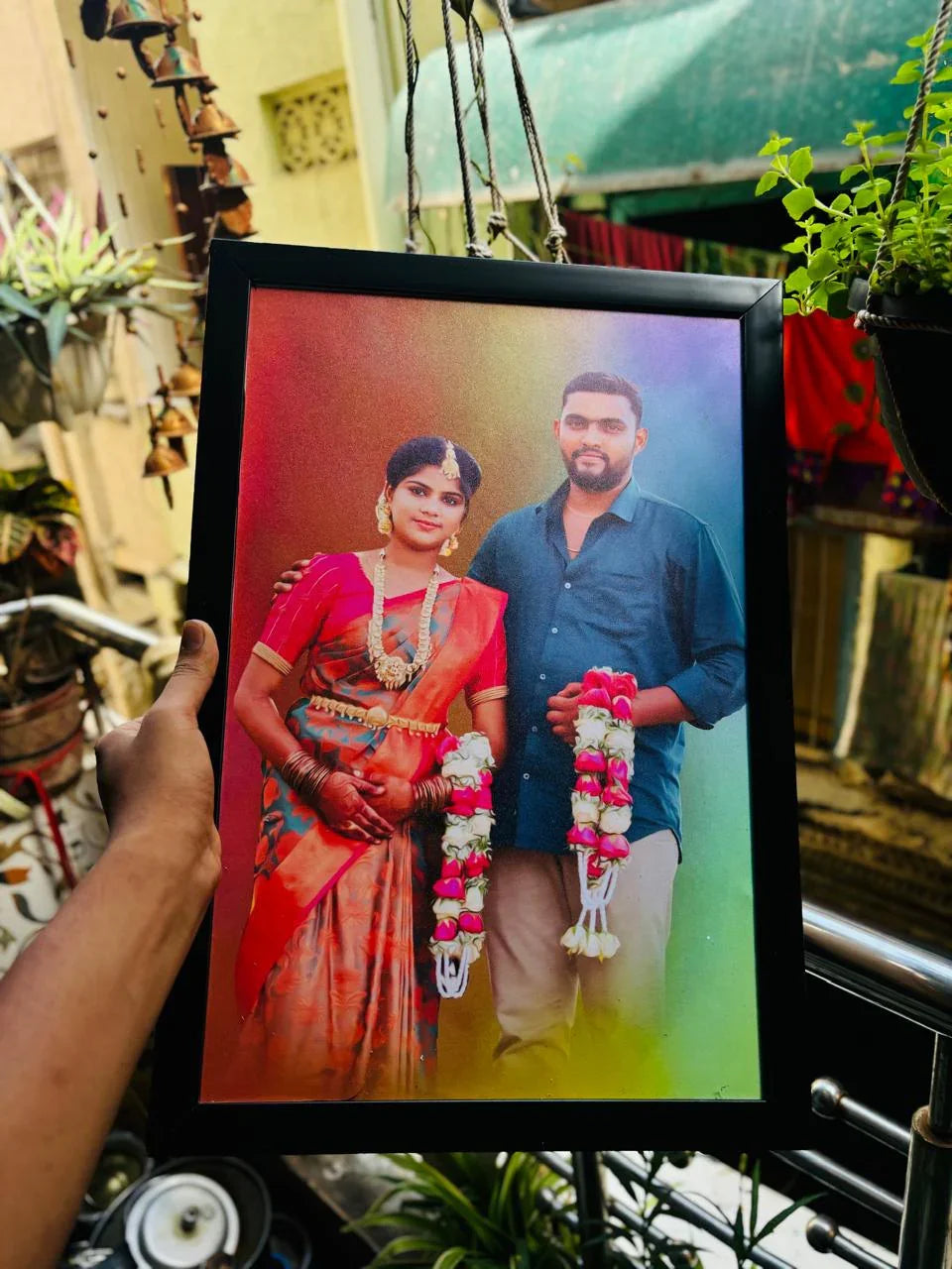 Framed Indian wedding photo of couple in traditional attire with flower garlands, perfect gift