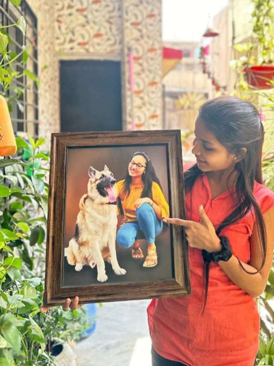 Woman holding framed photo of herself with German Shepherd dog, perfect personalized gift idea